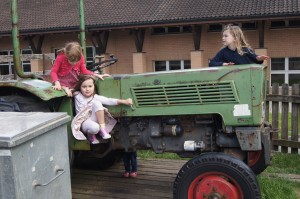 Lilly, Pia and Sophie playing on a tractor